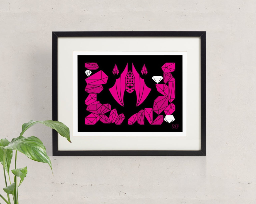 Baton Rouge bat screen print in fuschia and black with three bats hanging in their crystal cave, framed and hung on the wall.