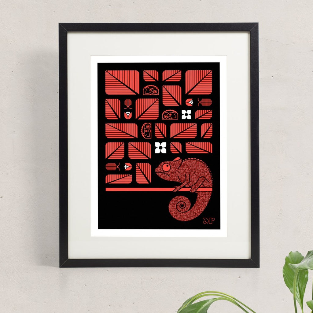 Chamelot screen print in red and black shows stylized chameleons resting in a tree among leaves and birds.