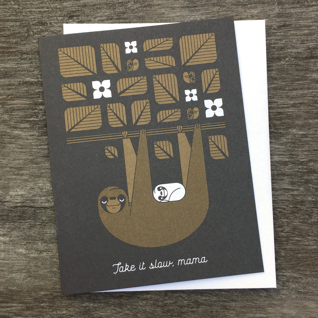 Take It Slow, Mama greeting card in brown and black. Shows a sloth with her cub hanging from a tree branch with leaves.