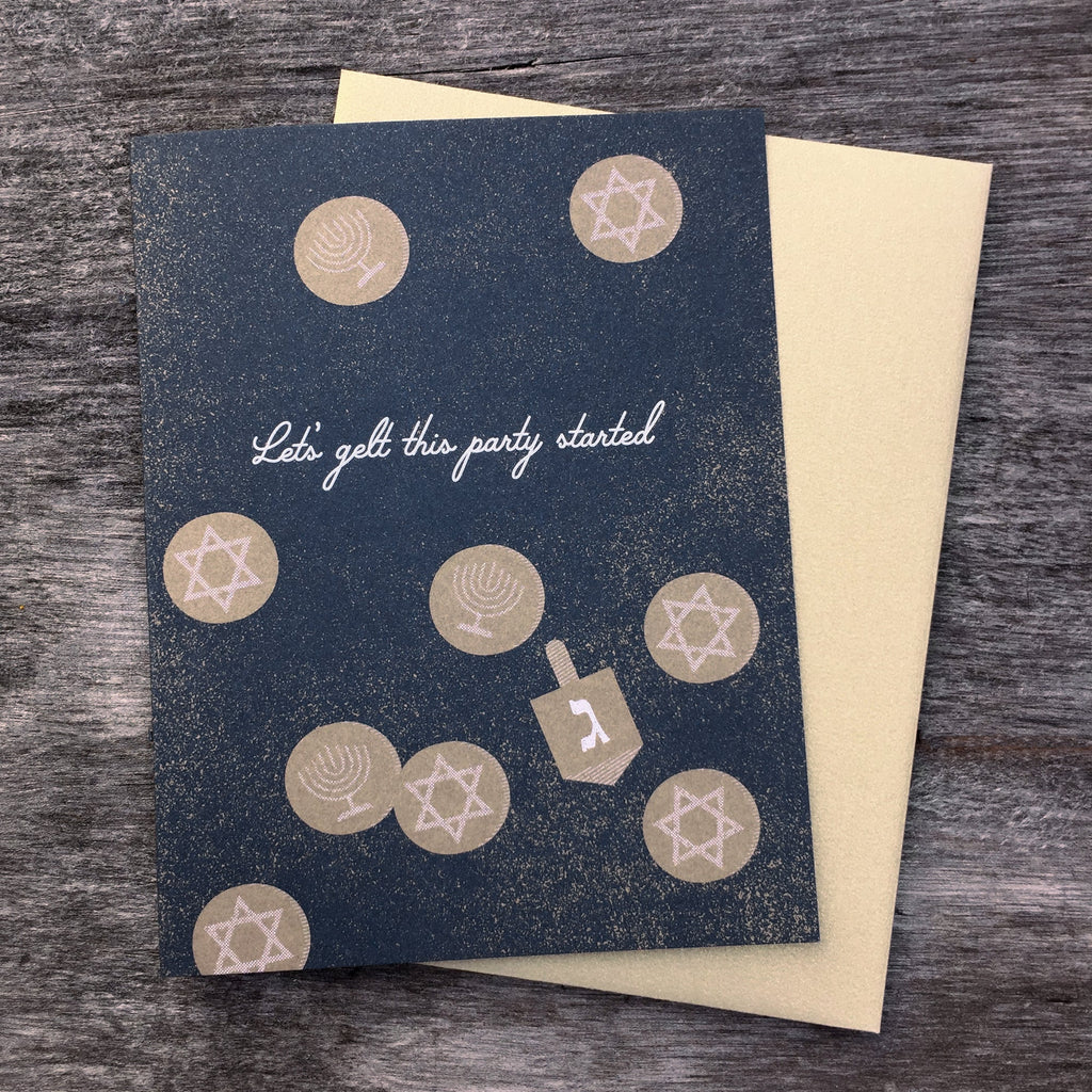 Let's Gelt This Party Started hanukkah greeting card. Dark blue background with gold dreidels and gold envelope.