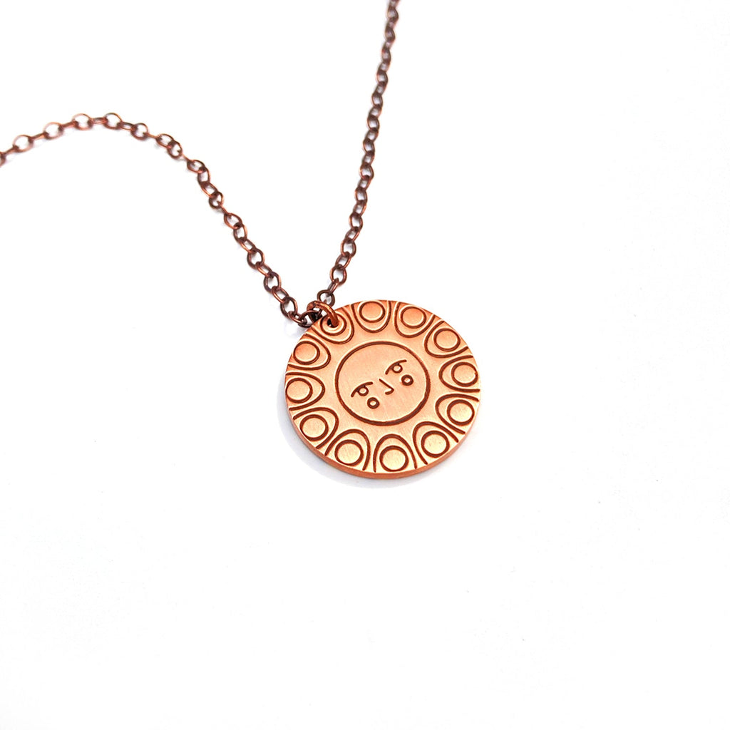 Reverse detail: Helios solar necklace. Shows the relief face detail on the back.