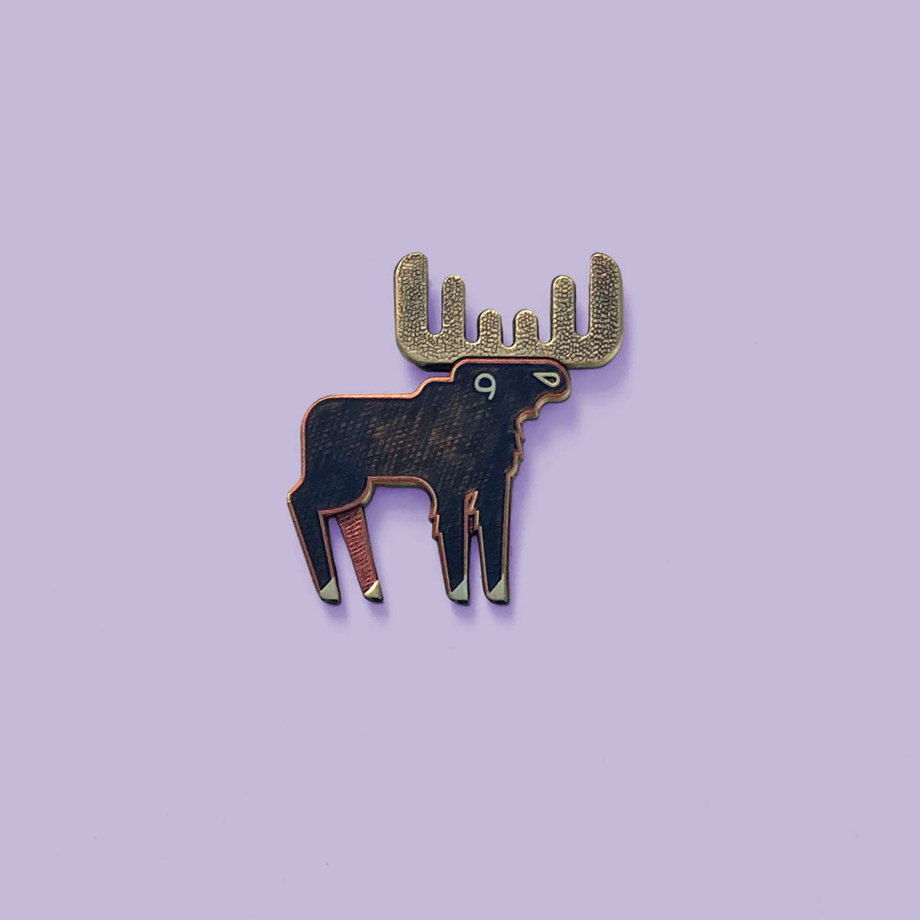 Moose pin with antique copper and bronze finish on a purple background