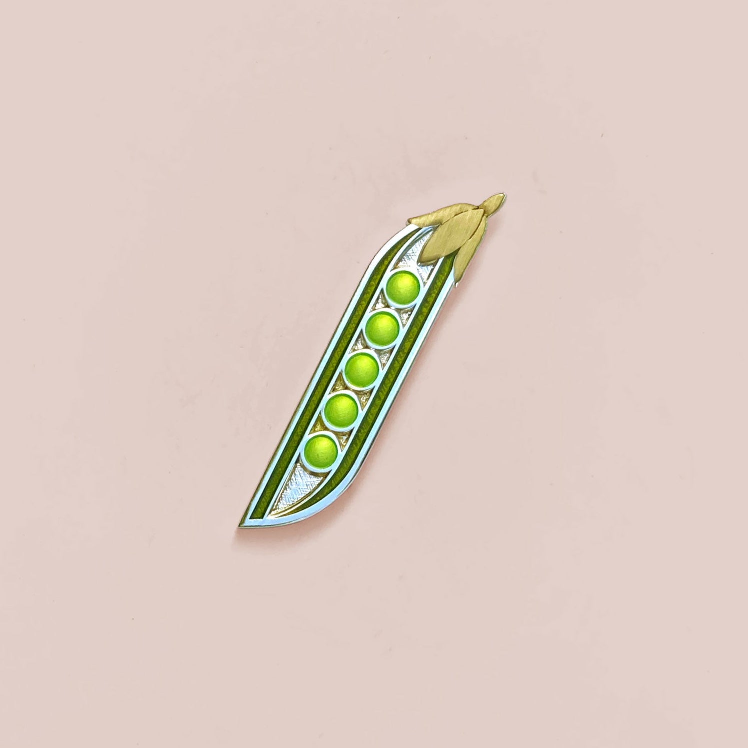 Green peas in a pod on a beige background
