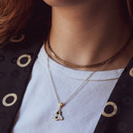 A person wearing a Mellona honeybee necklace showing how it sits near the collarbone.