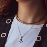 A person wearing a Mellona honeybee necklace showing how it sits near the collarbone.
