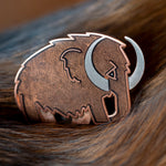 Woolly Mammoth enamel pin in silver with translucent brown enamel.