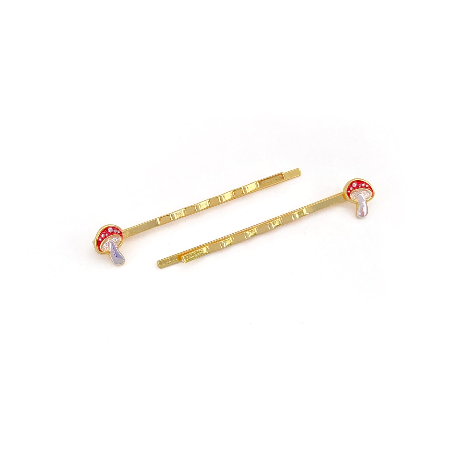 Amanita enamel mushroom hairpins in red with gold arms.