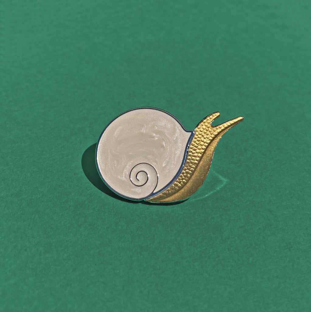Caracol snail pin in silver and antique bronze with pearlescent enamel.