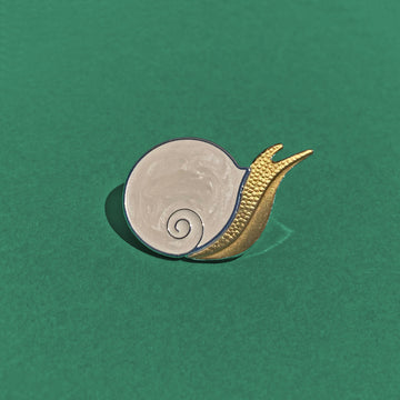 Caracol snail pin in silver and antique bronze with pearlescent enamel.