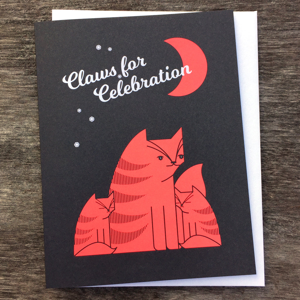 Claws for Celebration greeting card in red and black shows a cat and her kittens under a crescent moon and stars.