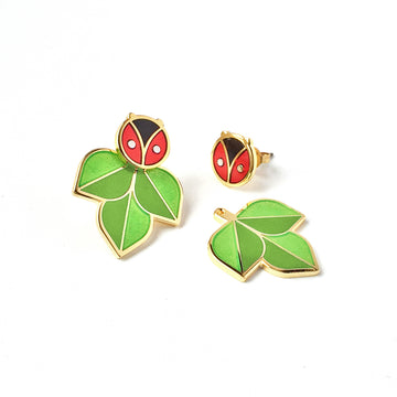 Coccinella red and black enamel ladybug or ladybird studs with two tone green leaf jackets in silver and 24k gold.