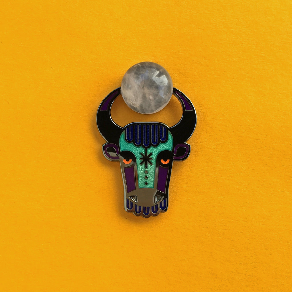 Enzu enamel bull or taurus pin in black, with rose quartz cabochon between its horns.