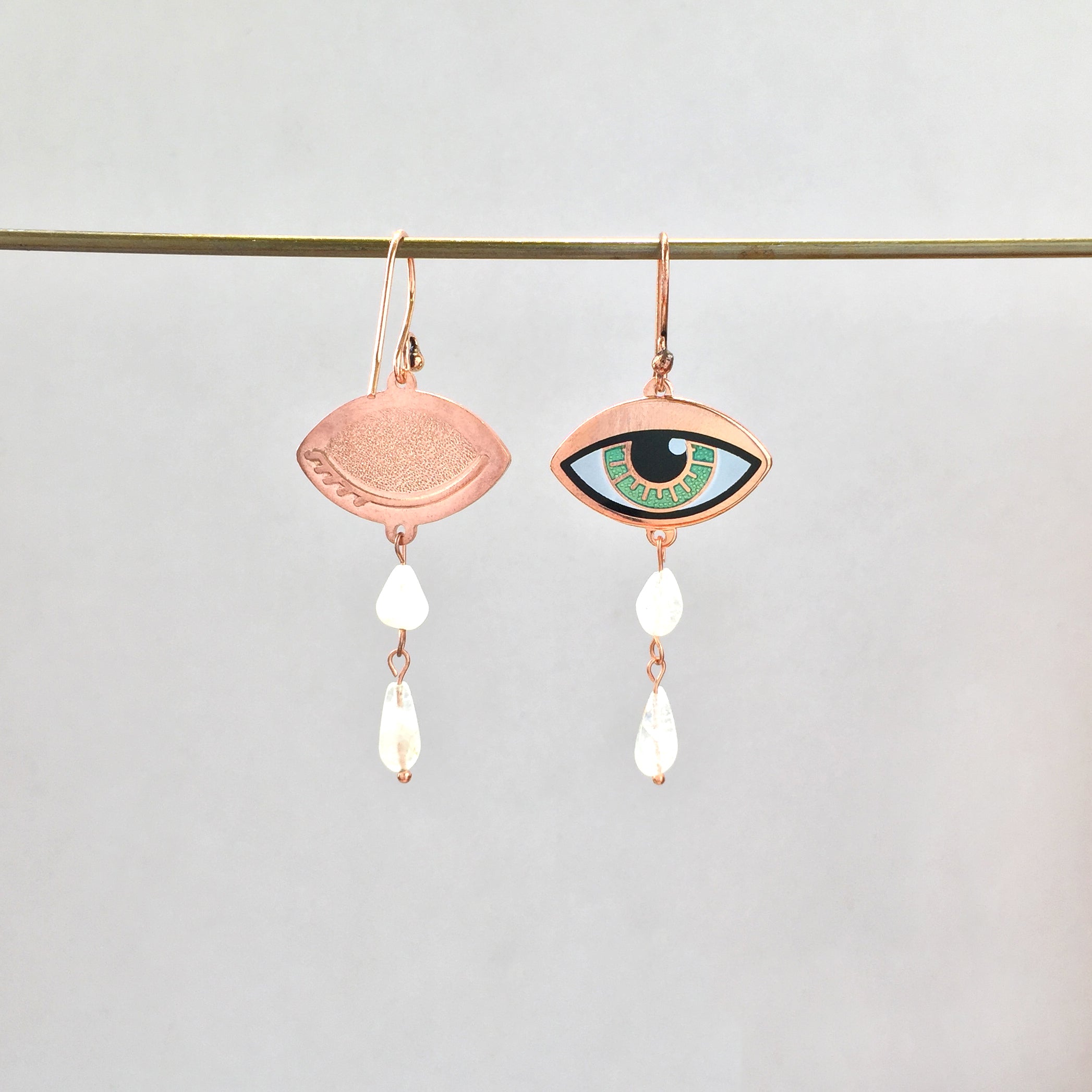 Ersa eye enamel earrings seconds with custom double rainbow moonstone teardrops showing the closed eye detail on the back.