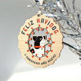 Laser woodcut Feliz Navidog holiday ornament showing a dog surrounded by festive lights in red, green and black.