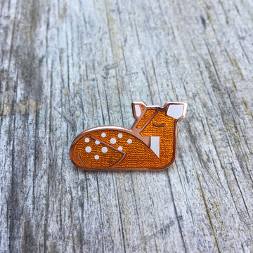 Goldie Fawn orange enamel deer pin in copper. Depicts a spotted fawn napping.