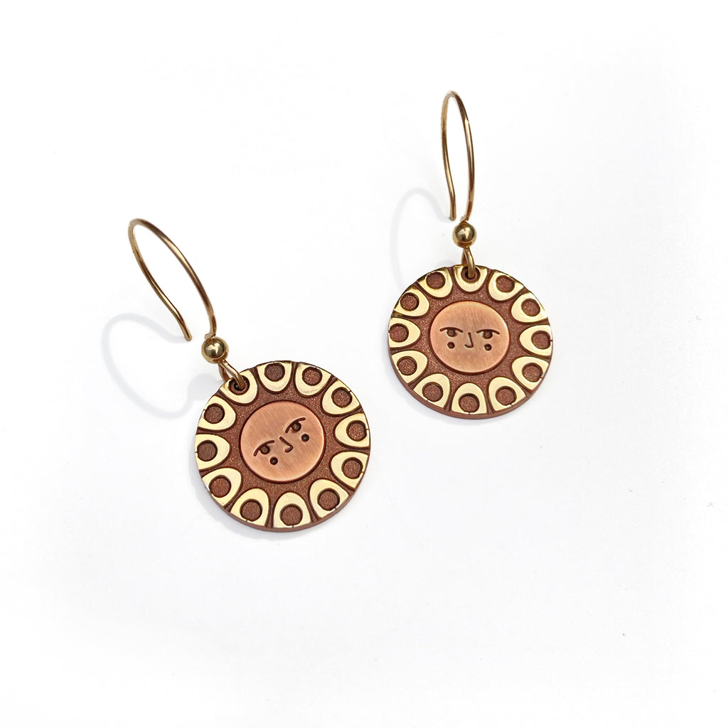 Helios solar earrings finished in 24k gold and antique copper. Shows a classic sun with face on gold filled french hooks.