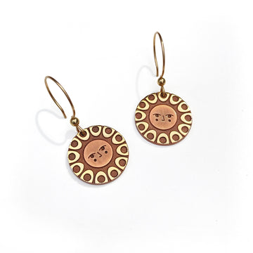 Helios solar earrings finished in 24k gold and antique copper. Shows a classic sun with face on gold filled french hooks.