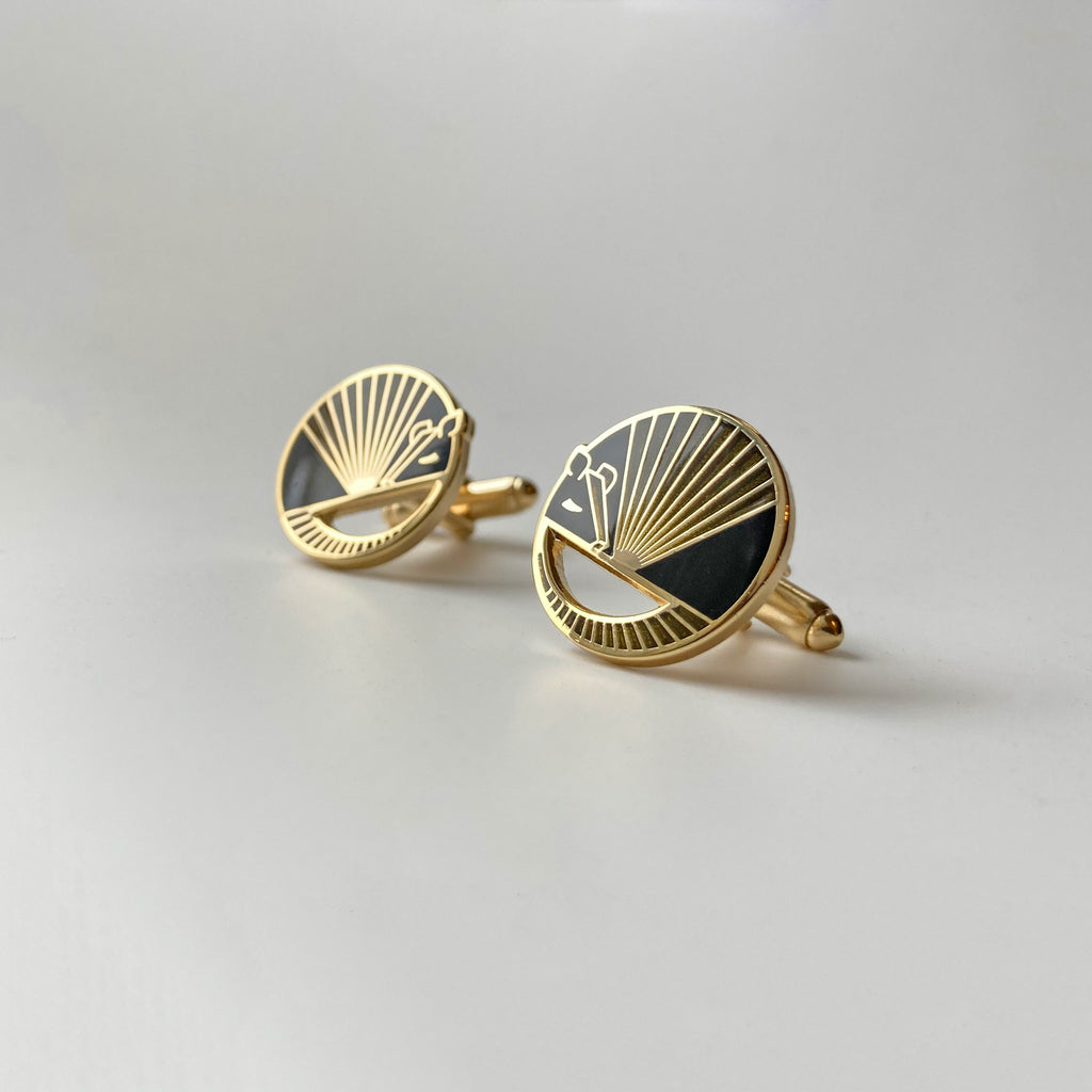 Karmadillo black enamel armadillo cufflinks finished in 24k gold with bullet toggle backs.