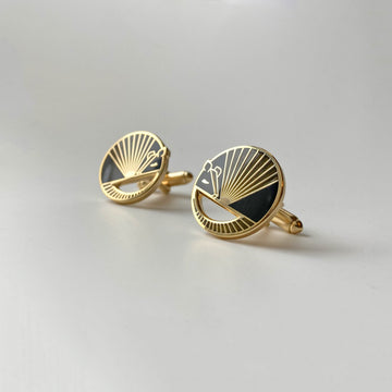 Karmadillo black enamel armadillo cufflinks finished in 24k gold with bullet toggle backs.