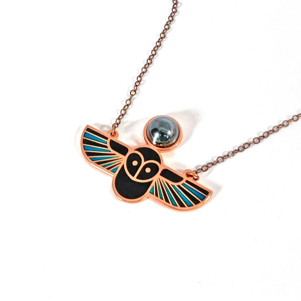Minerva owl necklace in copper with translucent blue and black enamel and hematite cabochon.