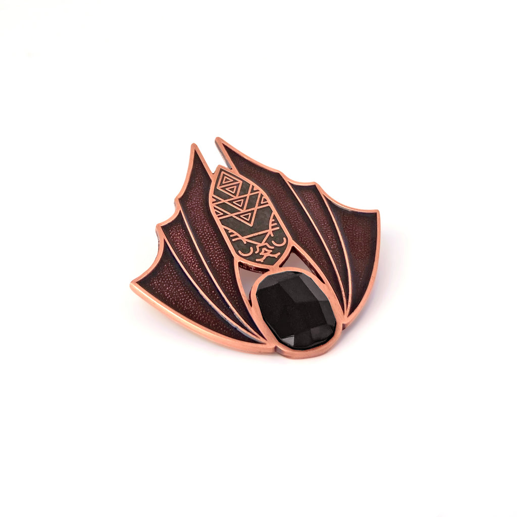 Minyades bat brooch in antique copper and translucent black enamel, with a black faceted siofourite crystal cabochon.