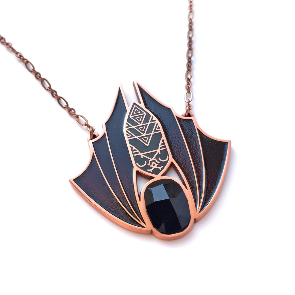 Minyades bat necklace in antique copper. Black enamel body, brown enamel wings and back siofourite crystal cabochon.