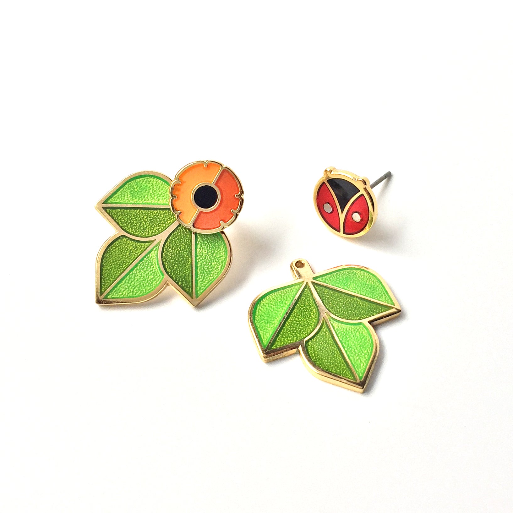Cross Pollination Jacket Earrings seconds with one each of anenome flower and coccinella studs and pair of leaf ear jackets.