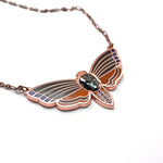 Atropos enamel death's-head moth necklace in copper seconds with black mirrored siofourite crystal skull.