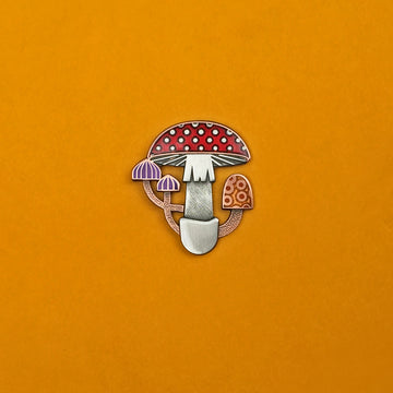 Mycelia mushroom enamel pin in antique copper and silver. With translucent red, purple and orange enamel.