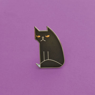 Not Amewsed black enamel cat pin in silver, with gold eyes and white-tipped tail.