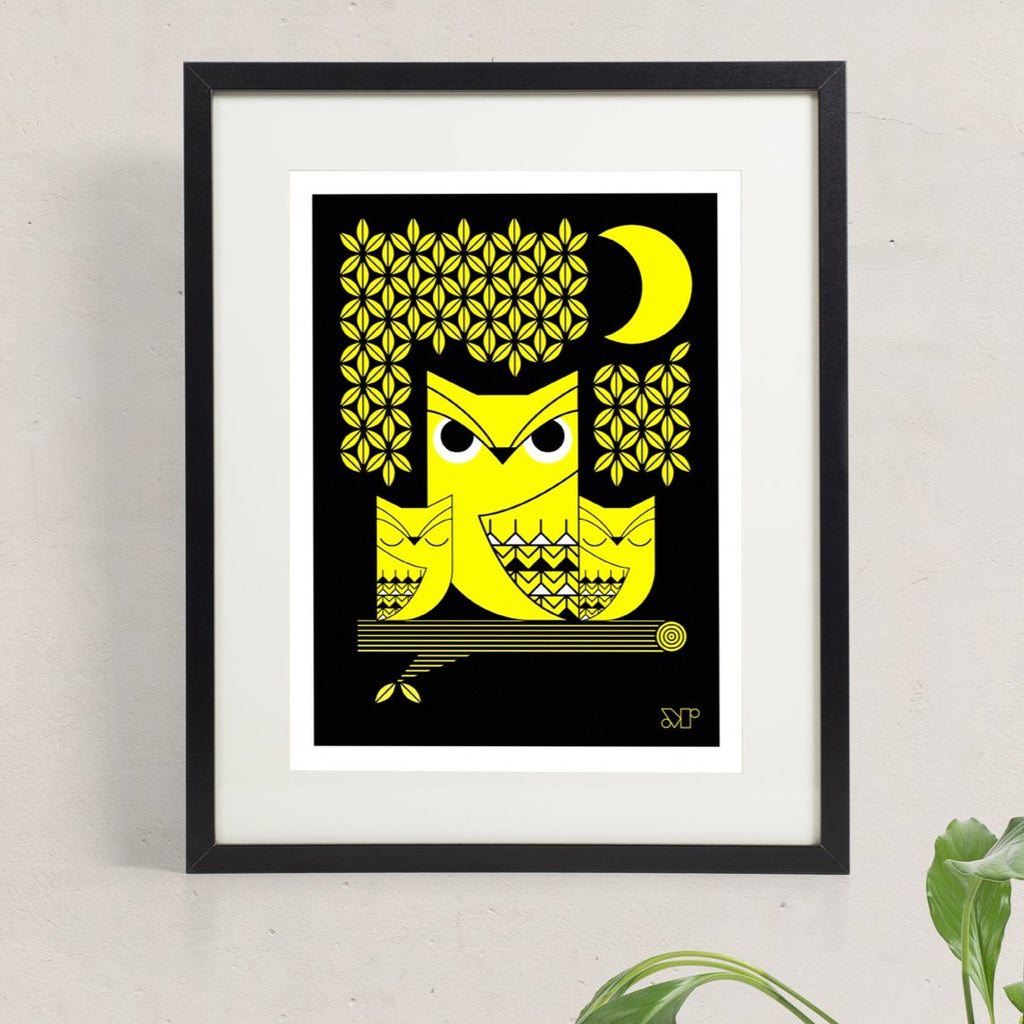 Doux Hiboux screen print in yellow and black depicts an owl with two owlets perched in a tree under a crescent moon.