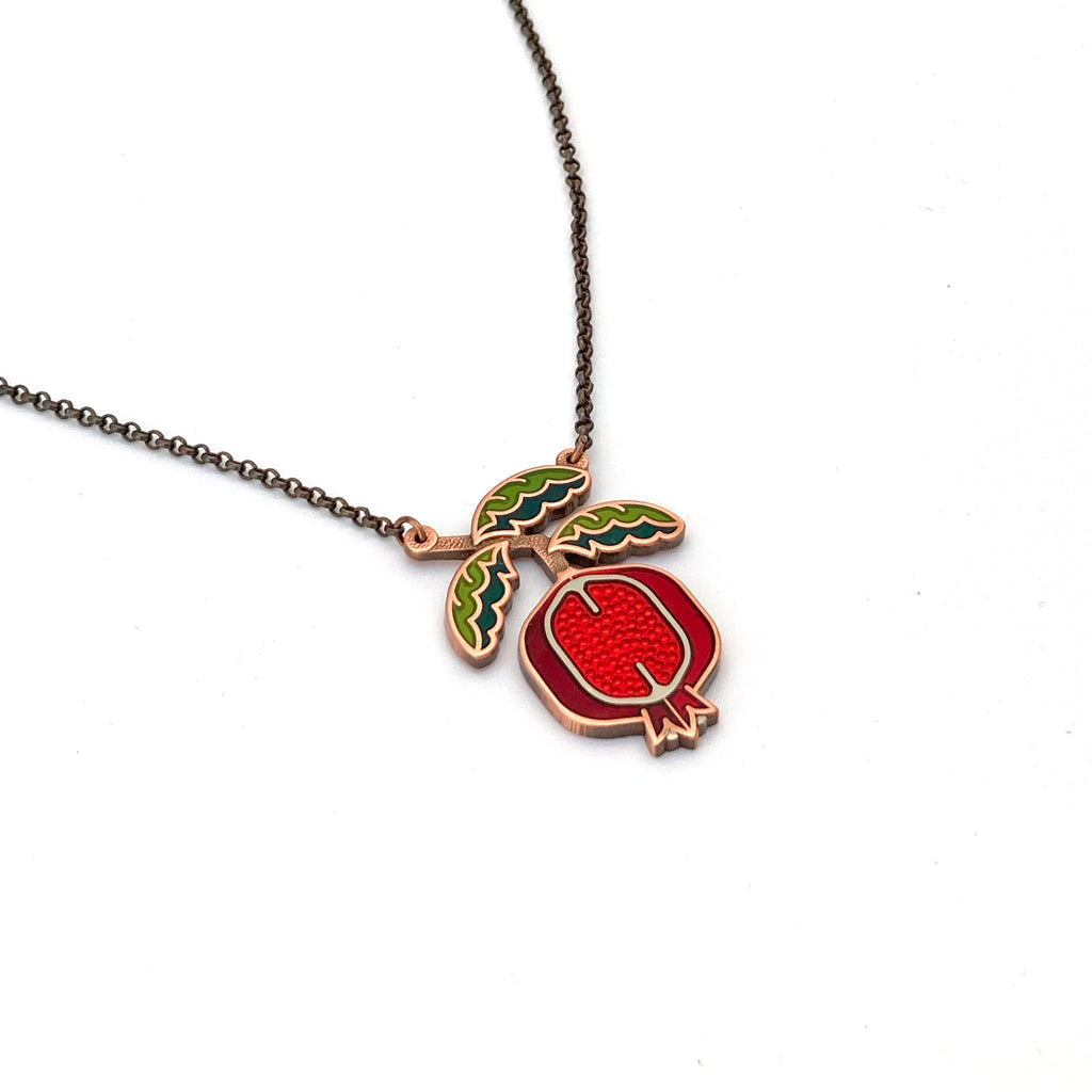 Pomegranate necklace finished in 24k gold and sterling silver. Green enamel leaf branch with red fruit and copper chain.