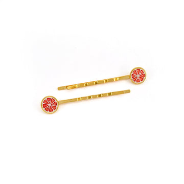 Ruby Red grapefruit hairpins finished in 24k gold and sterling silver with red enamel sliced fruit.