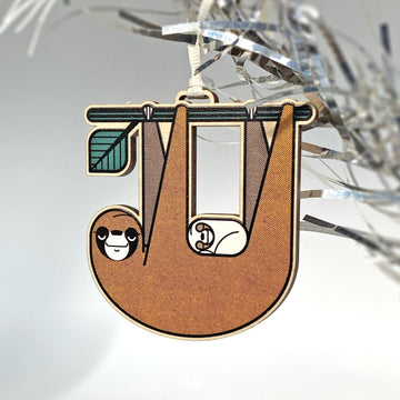 Slothlorien sloth and sleeping cub laser woodcut tree ornament. Printed in brown, black, white and green.