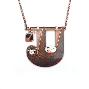 Slothlorien sloth and cub necklace in antique copper and translucent black enamel, with leaf dangle.