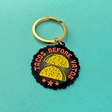 Tacos Before Vatos split-ring enamel keychain. Shows two tacos with surrounding text ≈ tacos before dudes.
