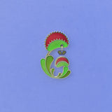 Venus Flytrap enamel pin. Dionaea muscipula in green, red and 24k gold finish. Fly dangle in silver and translucent wings.