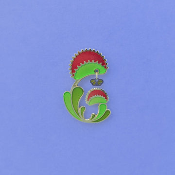 Venus Flytrap enamel pin seconds. Plant in green, red and 24k gold finish. Fly dangle in silver and translucent wings.