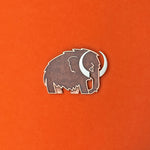 Woolly Mammoth enamel pin in silver with translucent brown enamel.